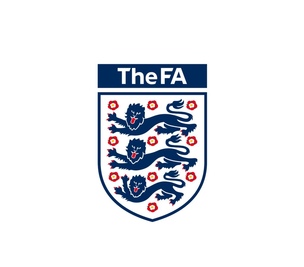 Logo of The FA (The Football Association), featuring a shield with three blue lions and 10 red roses, with the text 'The FA' above the shield in white on a navy blue background.