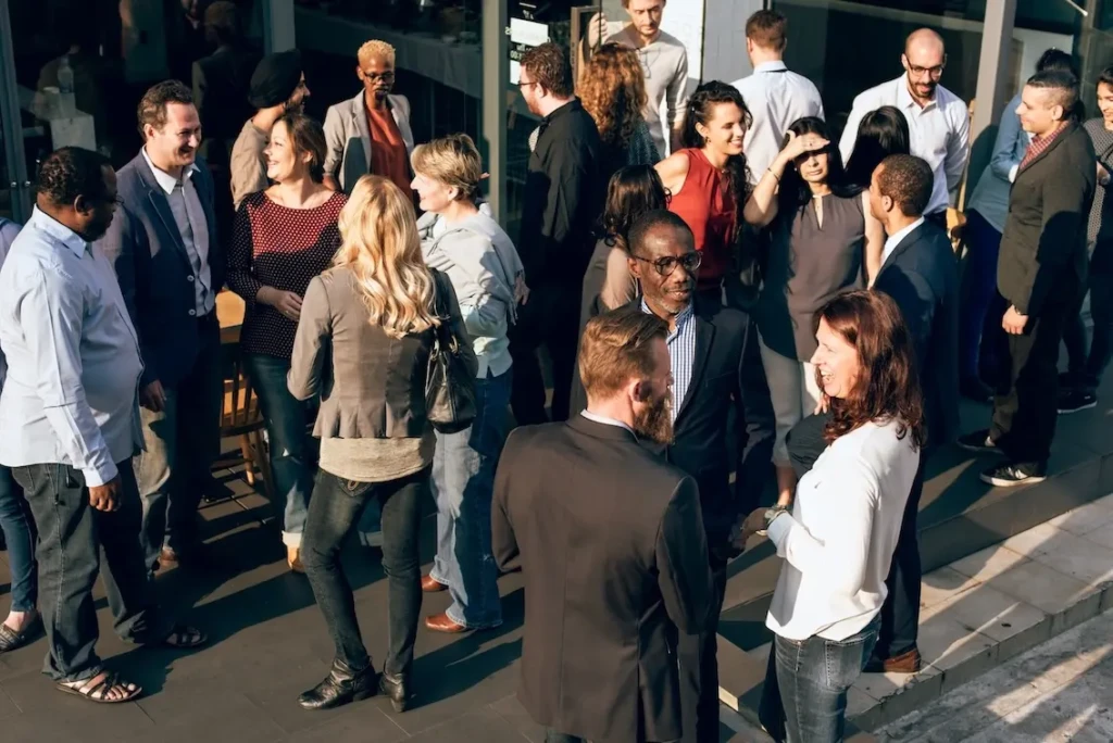 Groups of professionally dressed people, all having conversations. Represents users of VeryConnect's network management software.