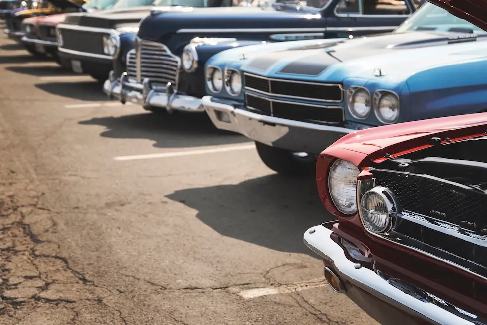 Vintage cars parked in a row. Represents a car event created on VeryConnect's car club software.