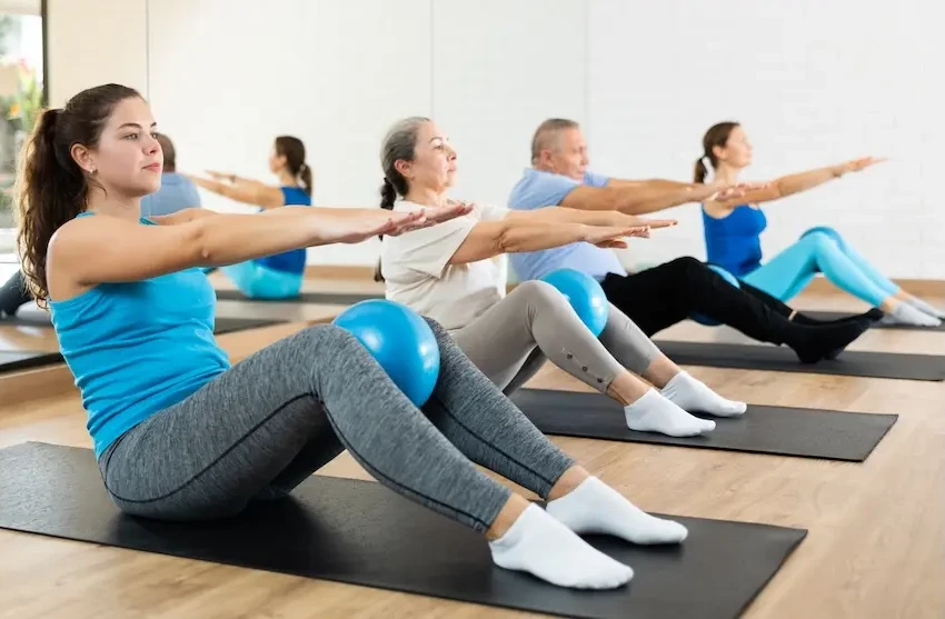 People on yoga mats doing gym exercises. Represent's users of VeryConnect's gym membership software.