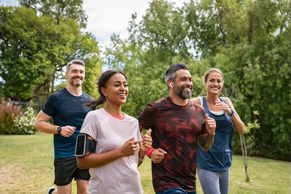 Four people jogging through a field. Represents users of VeryConnect's sports club membership software.