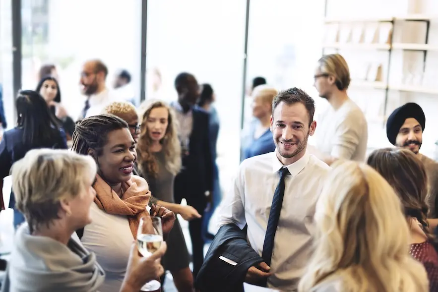 Group of professionally dressed people at a corporate event. Represent users of financial association software.